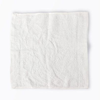 Close-up of the plush, absorbent terry cloth texture of a commercial-grade washcloth.