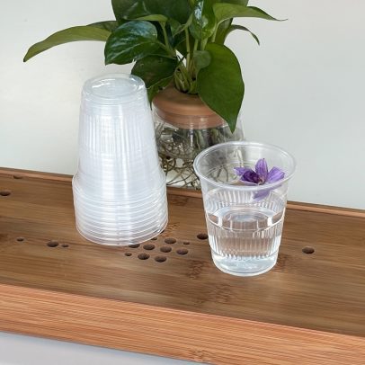 Stack of 5oz clear plastic juice cups for hotel beverage service