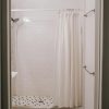White hotel shower curtain with hooks hanging neatly on rod