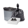 Black heavy-duty trash bag filled and tied, standing next to a trash bin