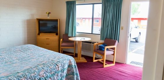 Well-designed hotel/motel guest room with modern furniture and cozy lighting