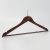 Angled view of mahogany men’s wooden hotel hanger with ball top