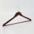 Angled view of mahogany hotel hanger for men with open hook