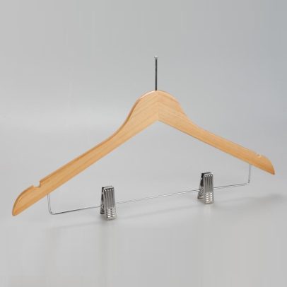 Angled view of women’s natural wood hotel hanger with chrome clips
