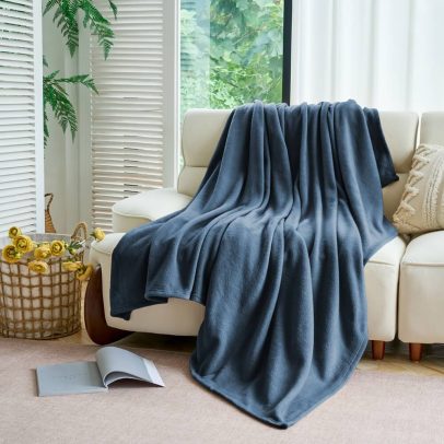 Angled close-up of blue full micro fleece blanket for hospitality
