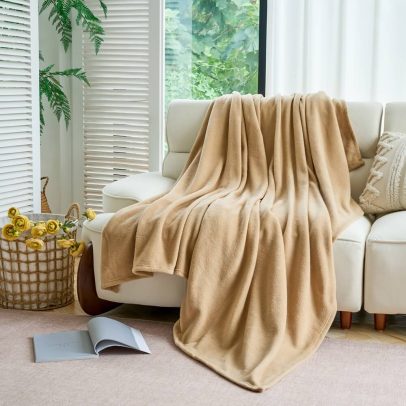 Angled close-up of queen tan micro fleece blanket, bulk-quality finish