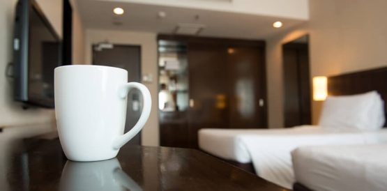 Modern hotel room interior with clean linens and welcoming amenities