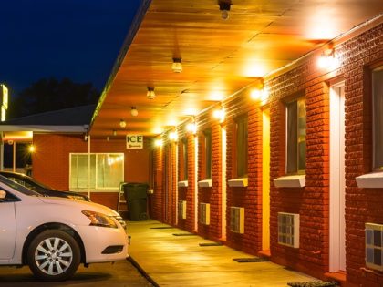 Night view of a classic, USA roadside motel exterior.