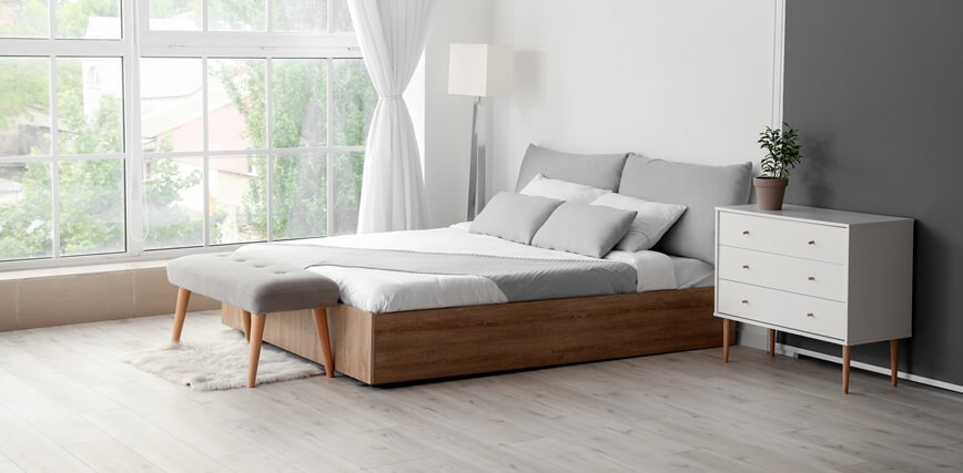 Standardized hotel room with fresh linens and amenities